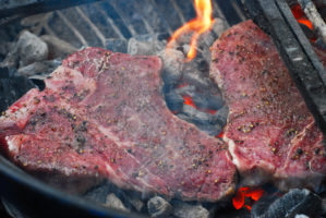 Porterhouse Steaks Grilled Directly On Hot Coals, aka “Cave Man Style” grilled porterhouse steak