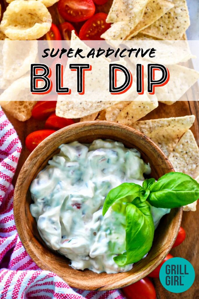 blt dip recipe with white dip in wooden bowl with sprig of basil for garnish and tortilla chips for serving