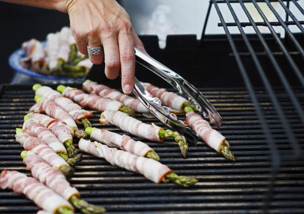 Silvia Prado flips the bacon wrapped asparagus