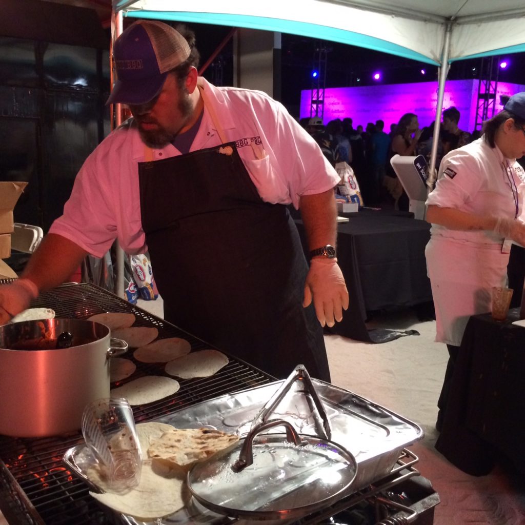 Ken Hess, Pitmaster for Big Bob Gibsons BBQ and right hand man to Chris Lilly, dishes up Pulled Pork Tacos.