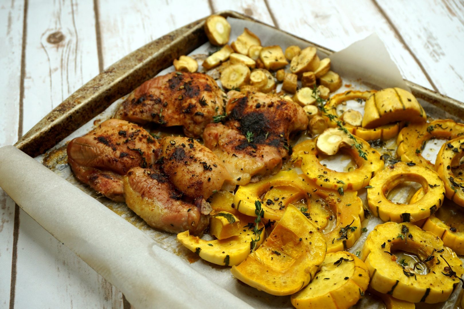 sheet pan dinner on pellet smoker_smoked chicken thighs and delicata squash on green mountain grill pellet smoker