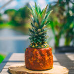 Pineapple wrapped ribs on a wooden cutting board.