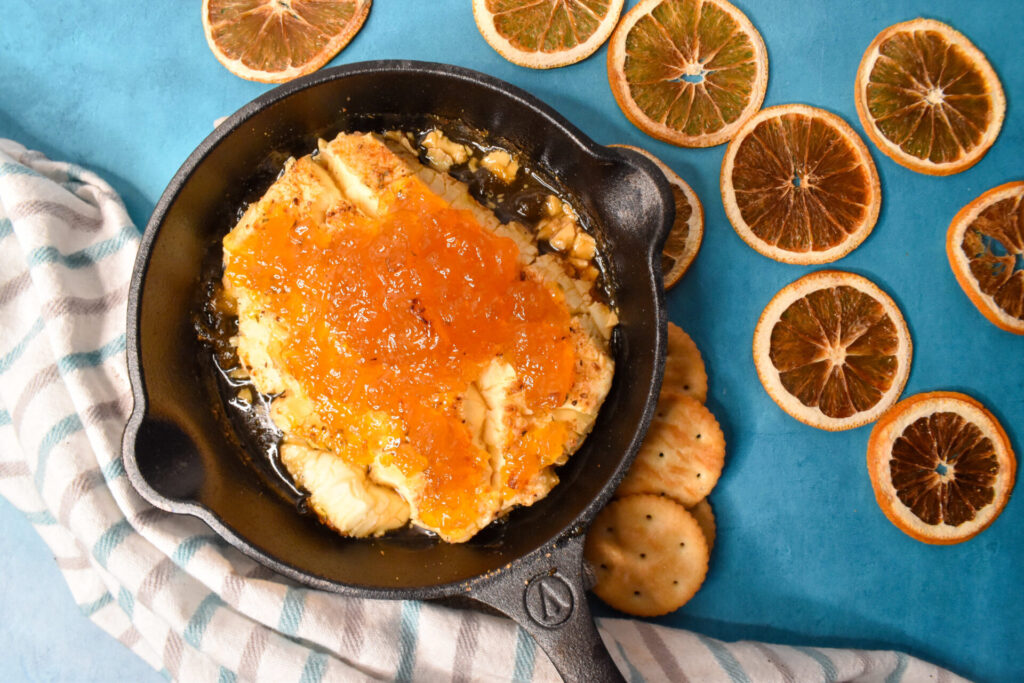 A cast iron skillet of pineapple preserve smoked cream cheese.