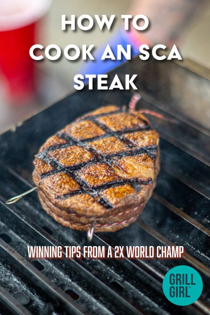 A grilled SCA Steak with crosshatch grill marks cooks on a barbecue grate. Overlaid text reads, How to Cook an SCA Steak. Winning tips from a 2x World Champ. Grill Girl.